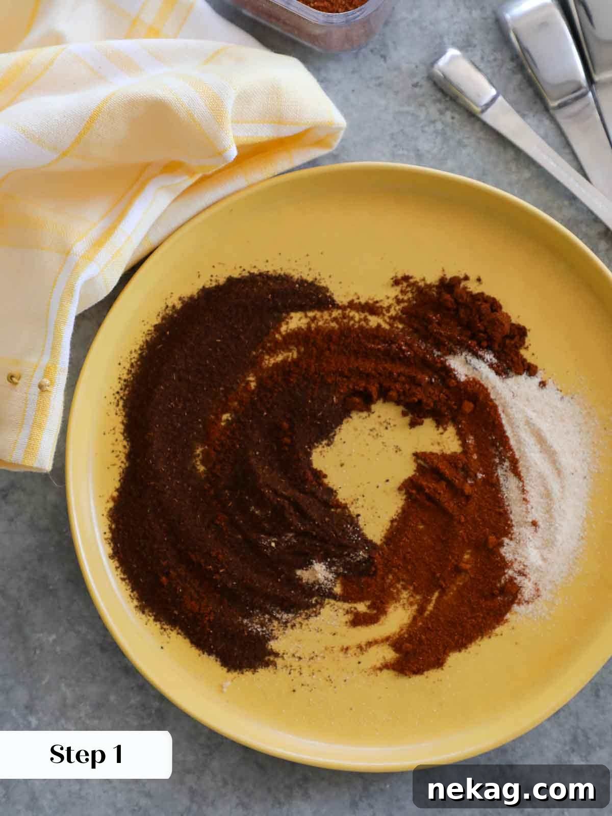 Homemade taco seasoning ingredients being whisked together in a bowl on a yellow plate.