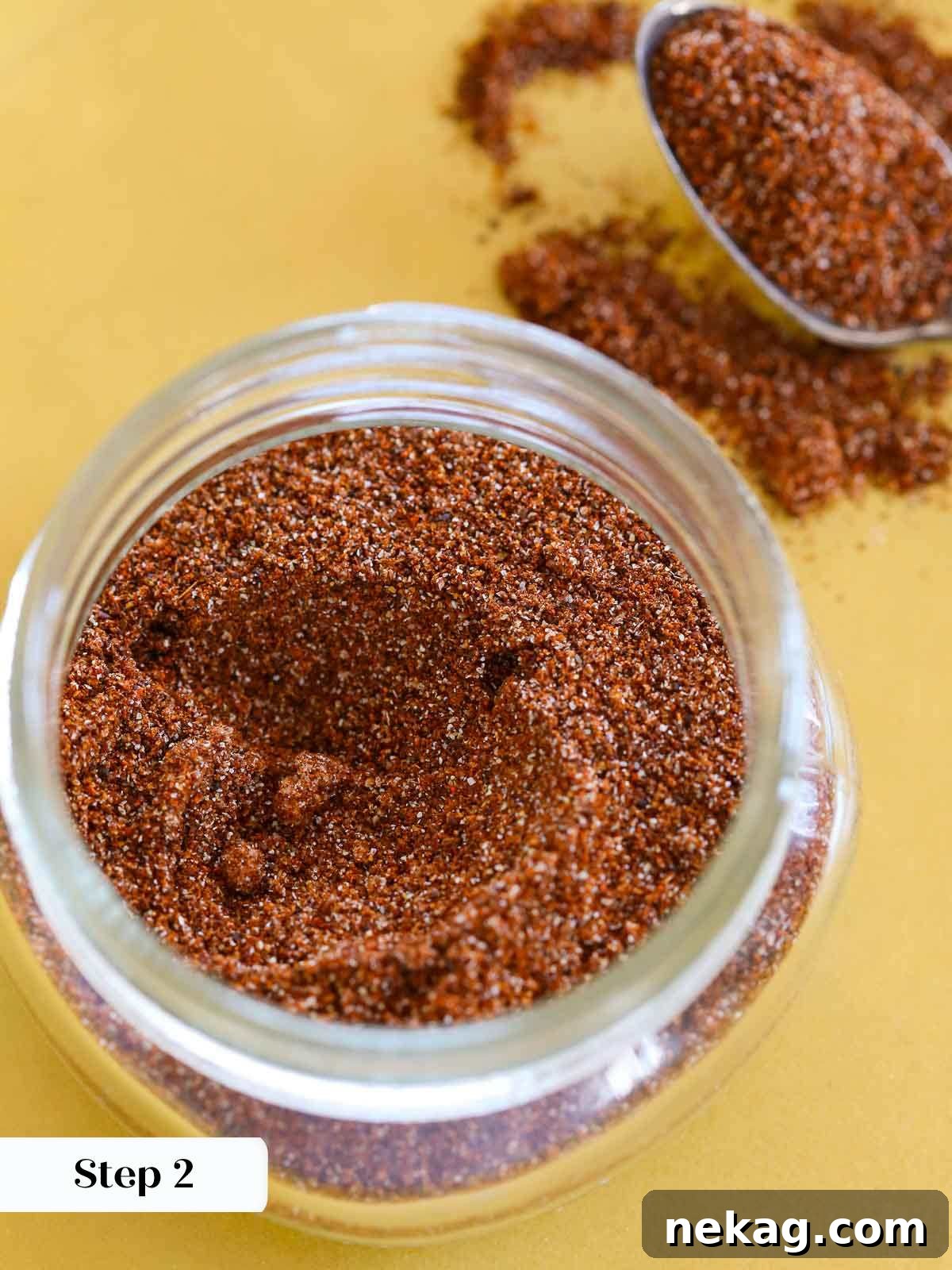 Homemade taco seasoning pouring from a jar onto a yellow plate.