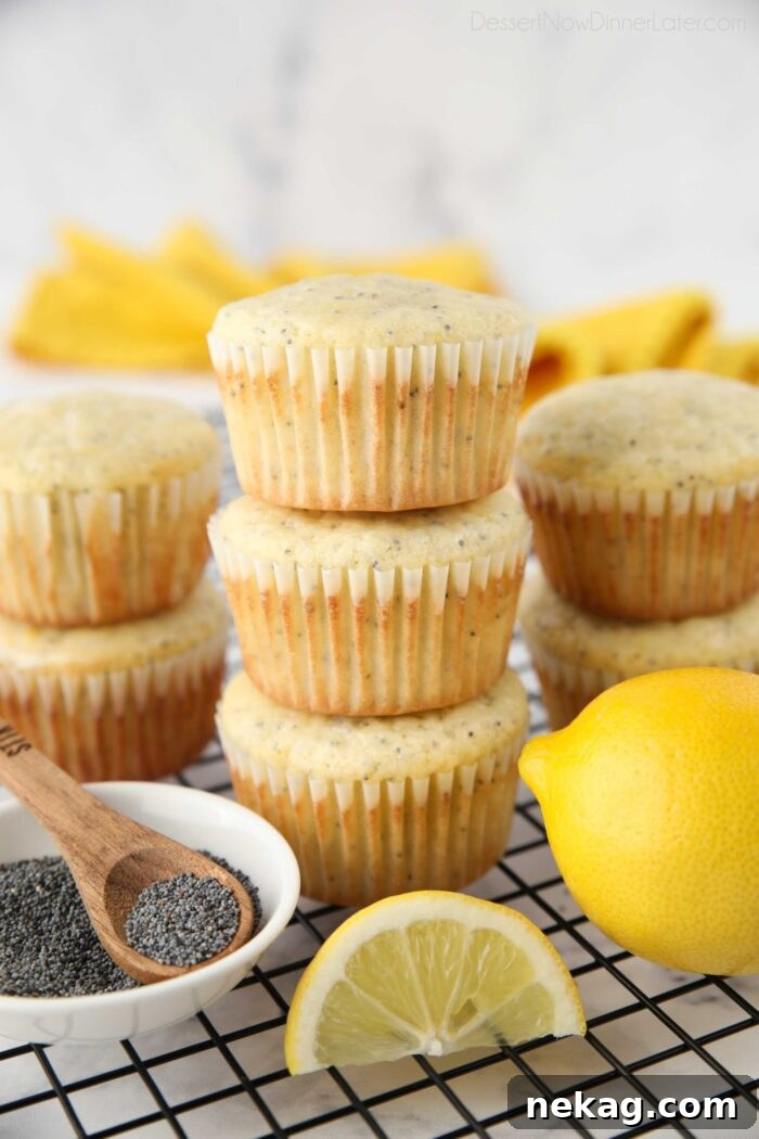 A stack of golden-brown lemon poppy seed muffins, showcasing their appealing texture and inviting aroma.