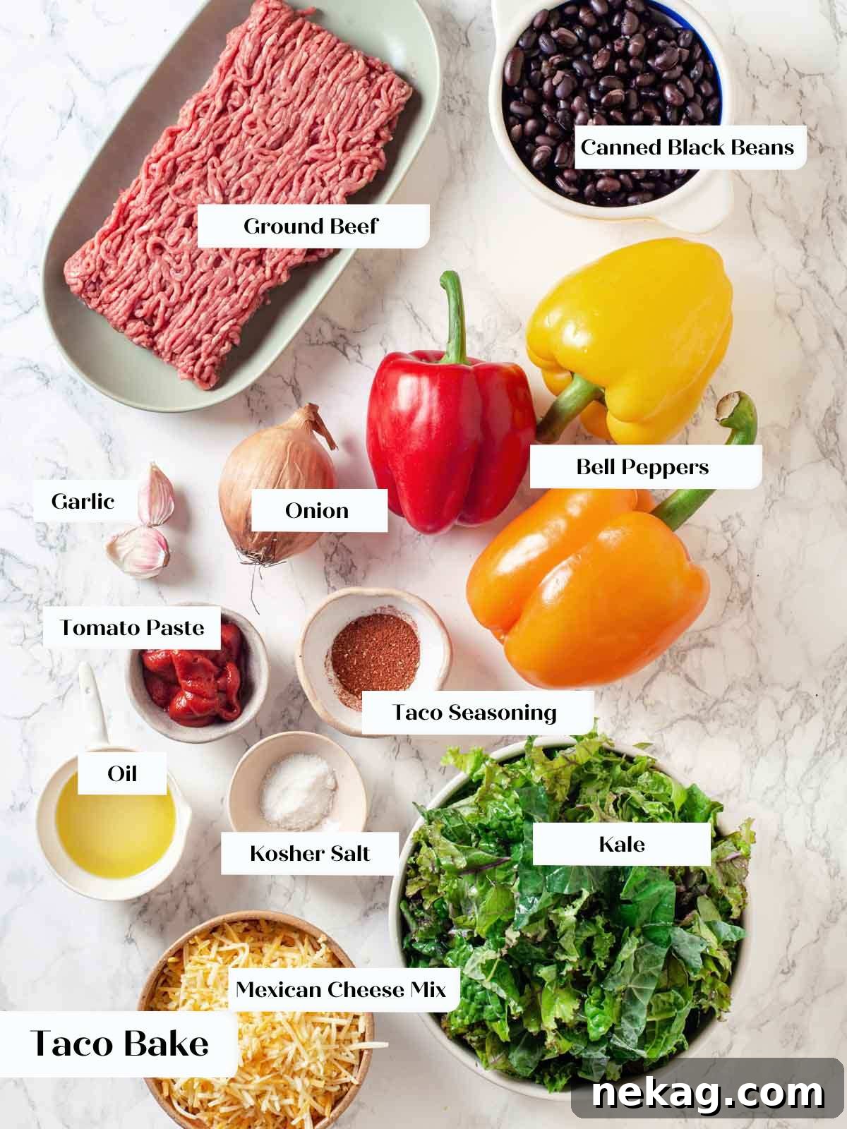Main ingredients for taco bake, including bell peppers, kale, ground beef, and cheese, arranged on a marble countertop.