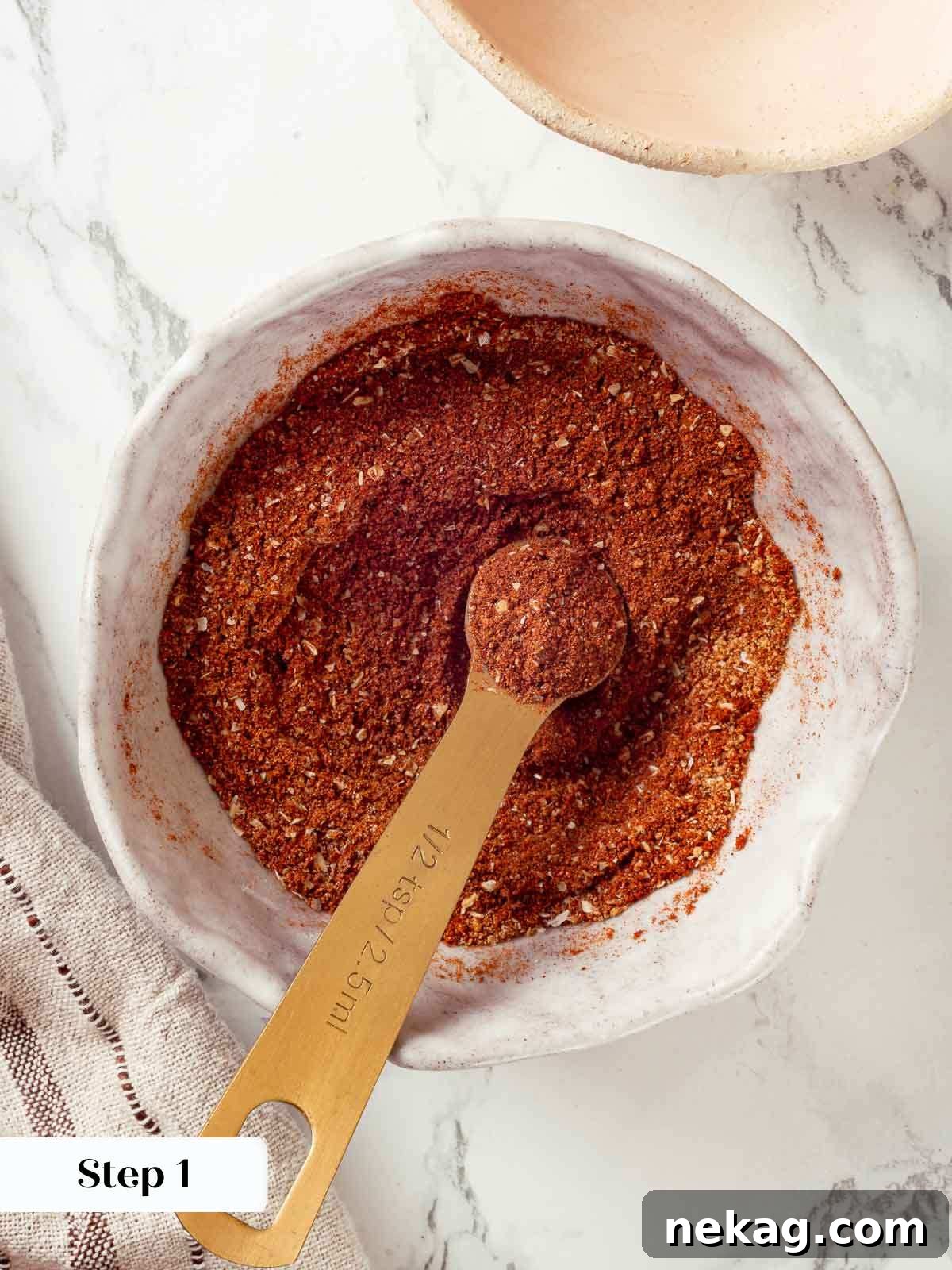 Close-up of taco seasoning being mixed in a bowl, showing the vibrant colors of the spices.