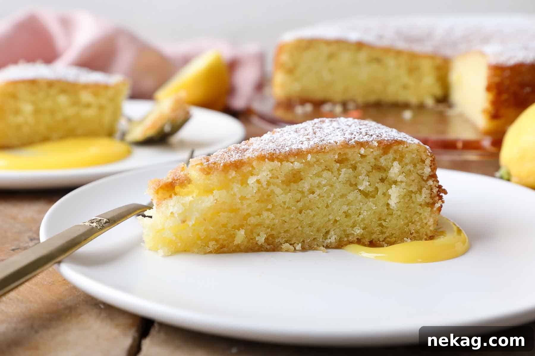 Sun-Kissed Lemon Olive Oil Cake 5 side of a slice of lemon olive oil cake on white plate.