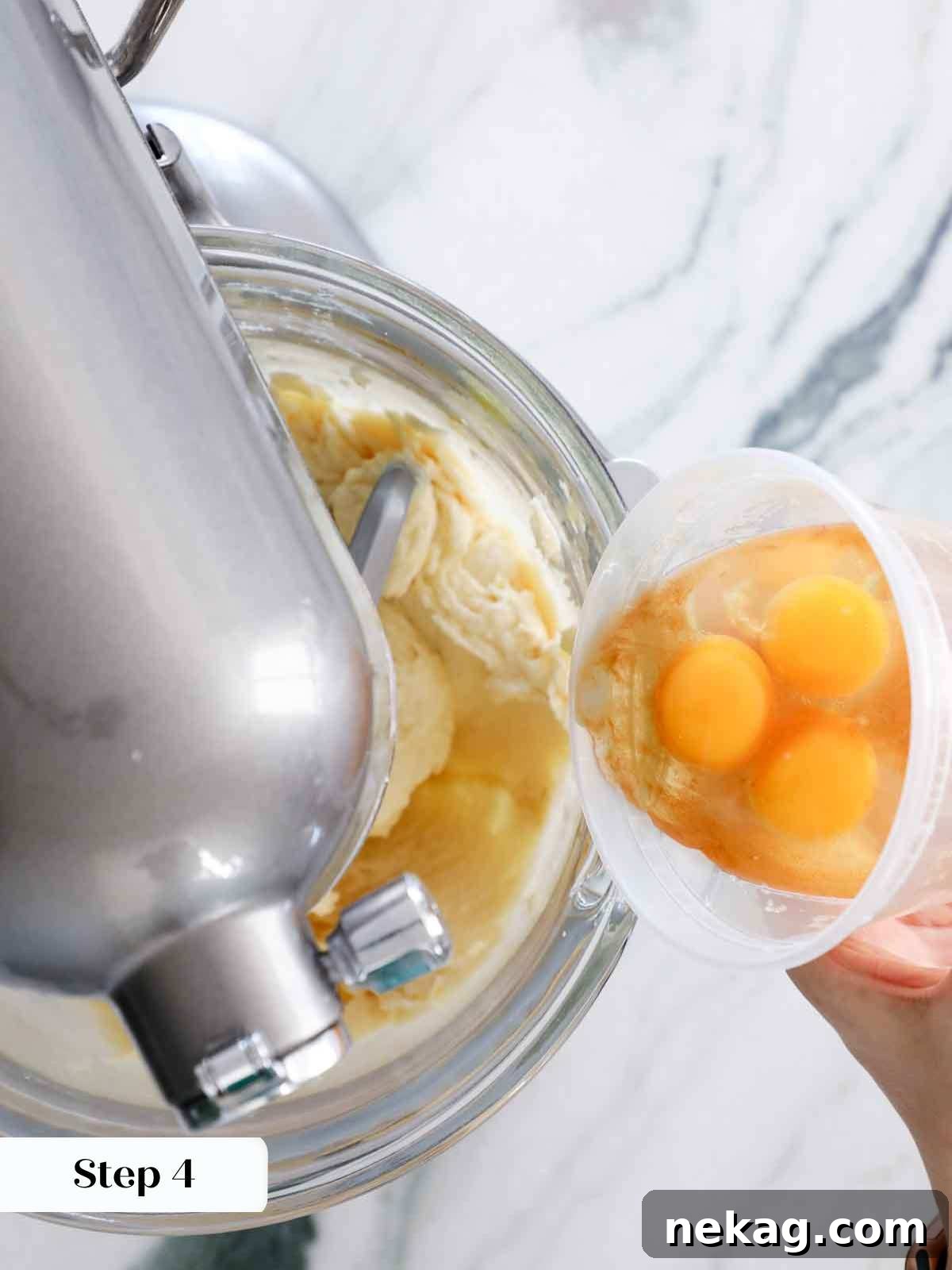 Perfectly Moist Vanilla Cake 12 adding eggs to cake batter.