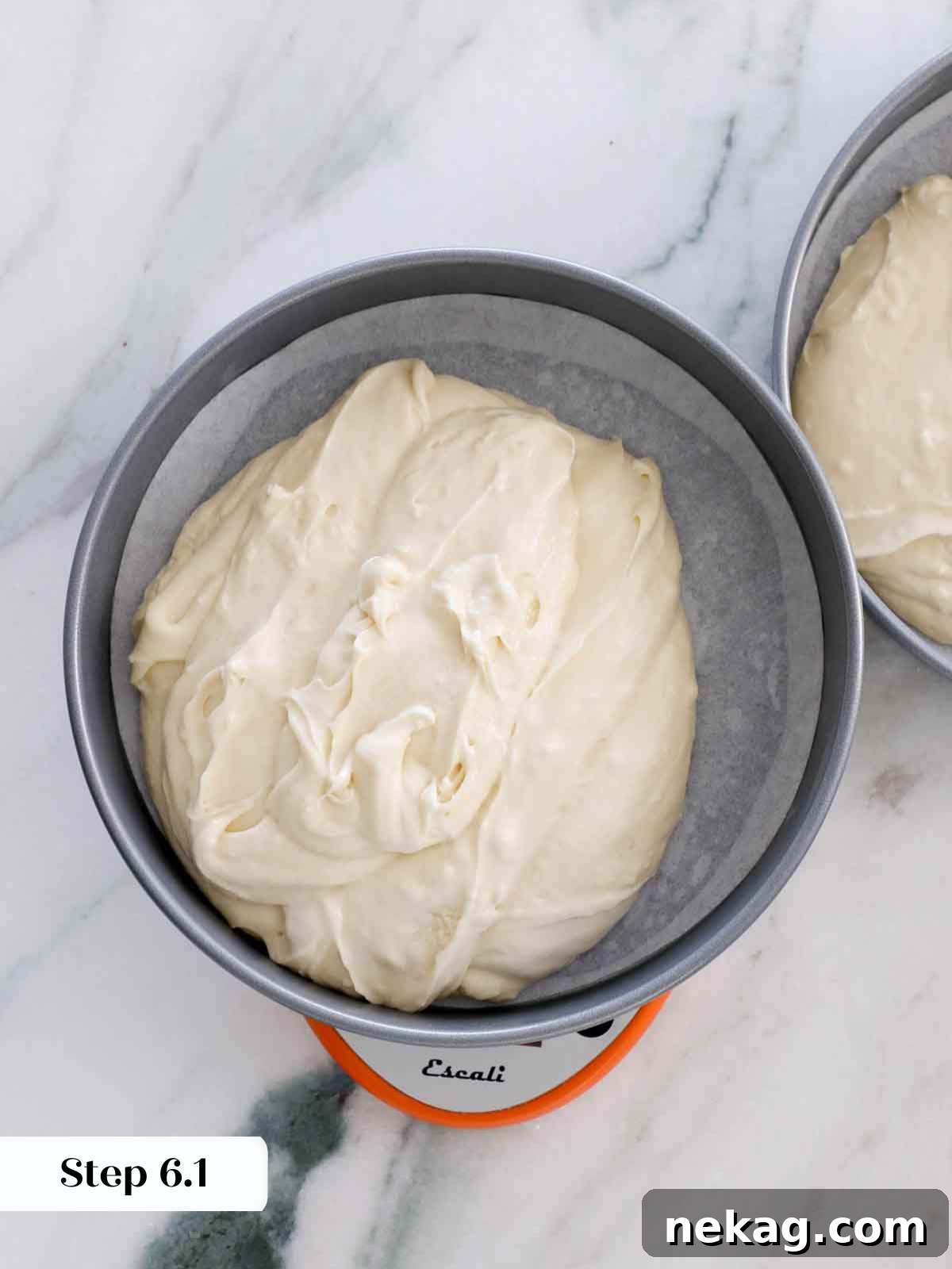 Perfectly Moist Vanilla Cake 14 dividing batter between cake pans.
