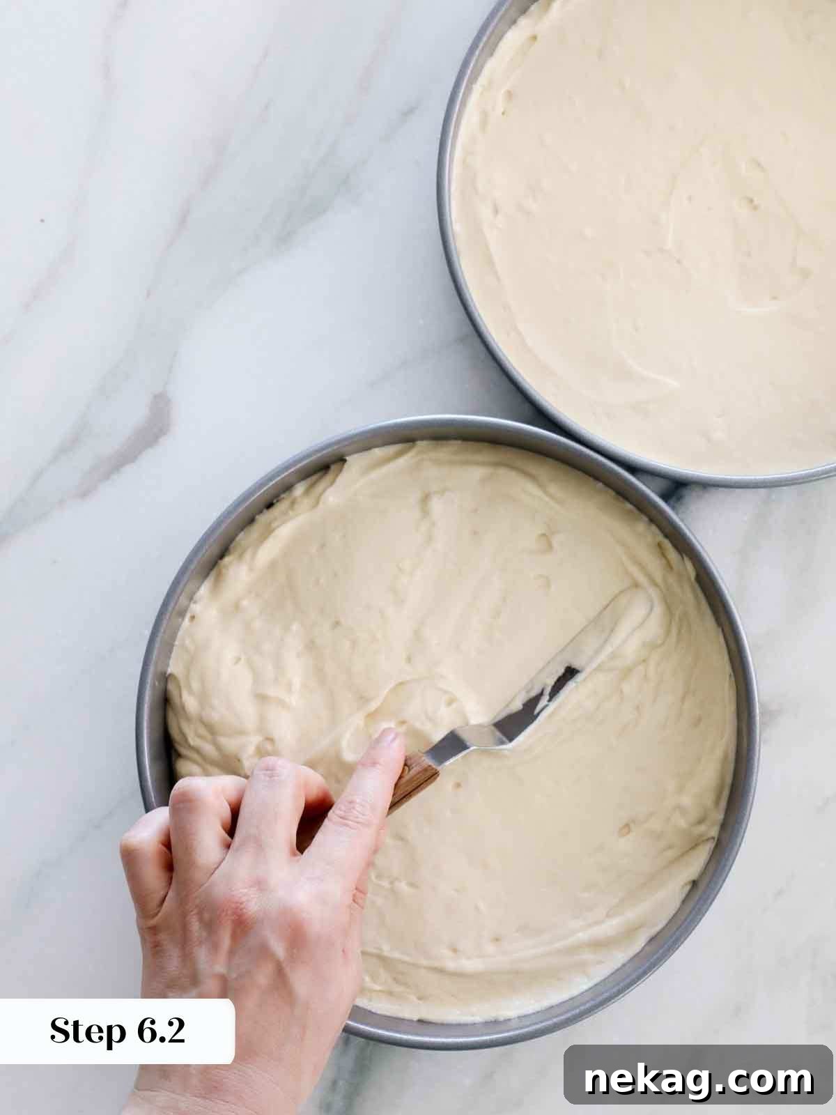 Perfectly Moist Vanilla Cake 15 smoothing cake batter between pans.