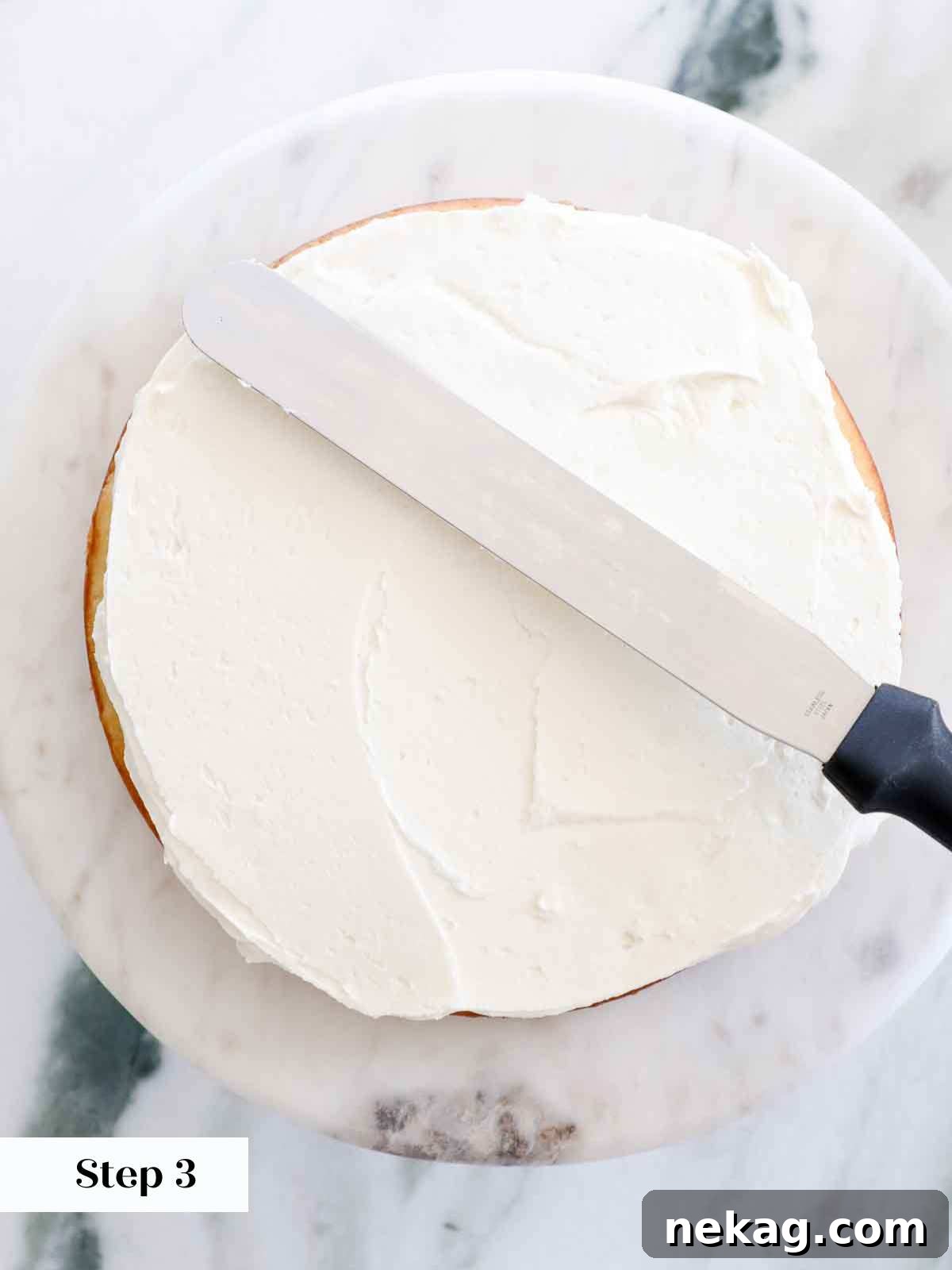 Perfectly Moist Vanilla Cake 22 smoothing out buttercream between layers.