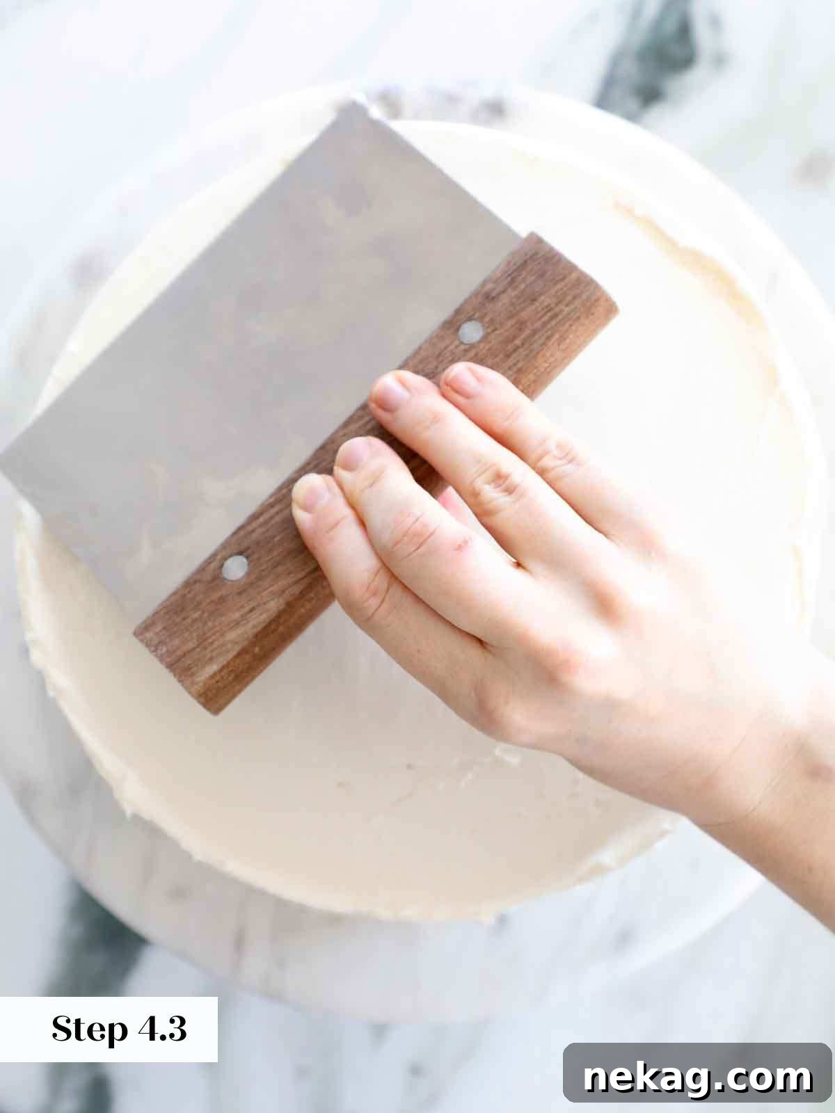 Perfectly Moist Vanilla Cake 25 smoothing top of vanilla cake buttercream.
