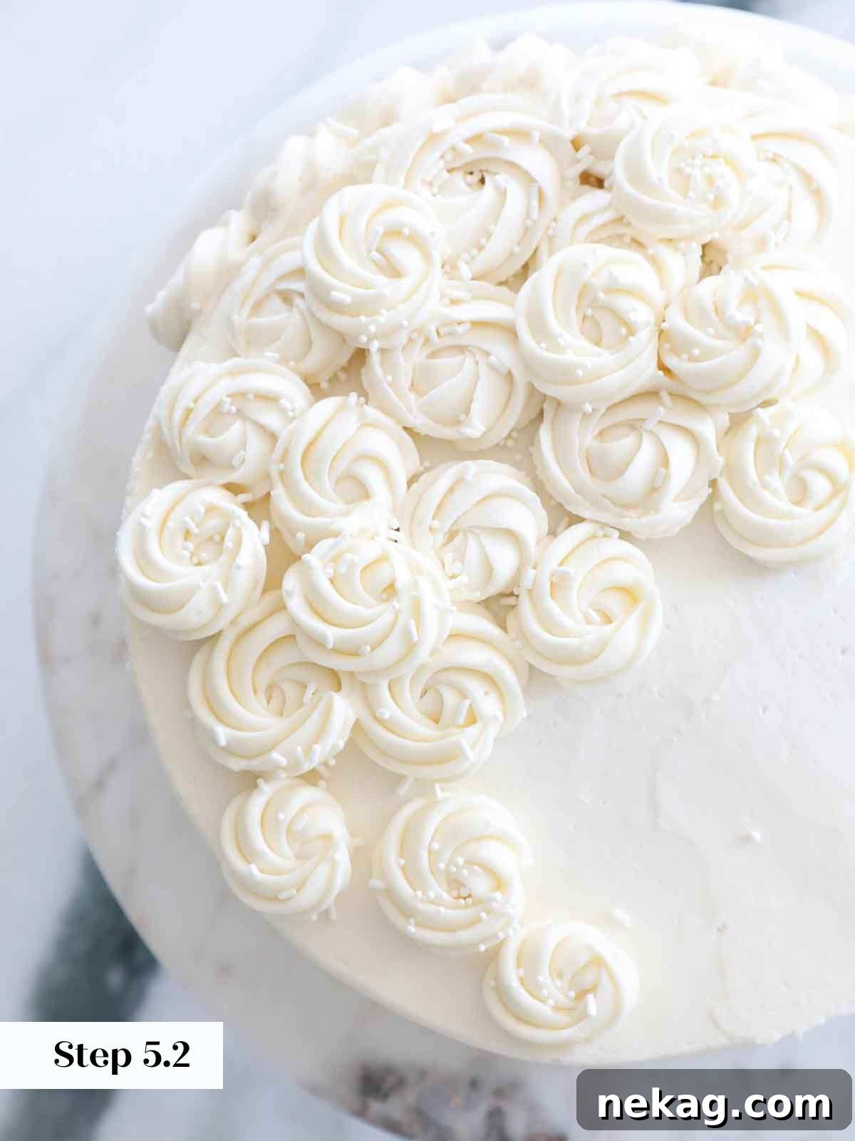 Perfectly Moist Vanilla Cake 27 piped vanilla american buttercream rosettes on cake.