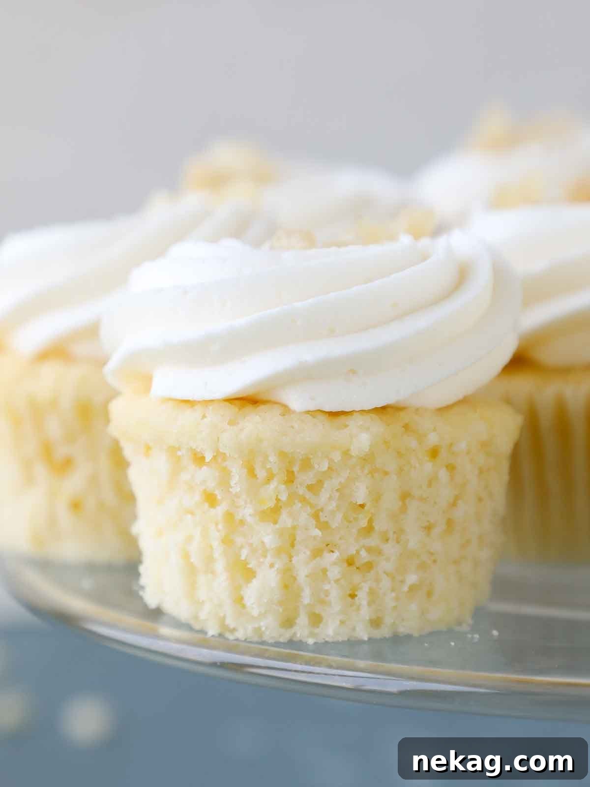 Sunshine Lemon Cupcakes 2 A single unwrapped lemon cupcake, showcasing its fluffy texture and golden color.