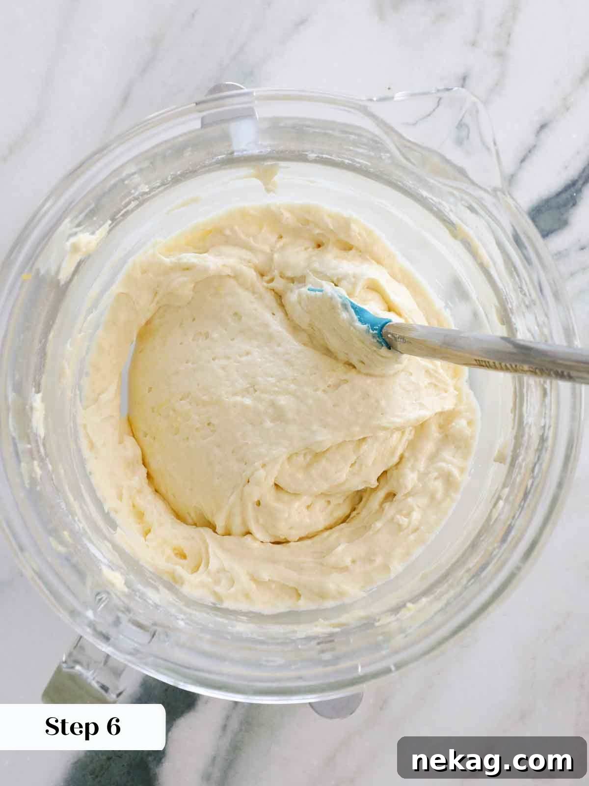 Sunshine Lemon Cupcakes 11 Finished lemon cupcake batter in a clear mixing bowl, showcasing its smooth consistency.