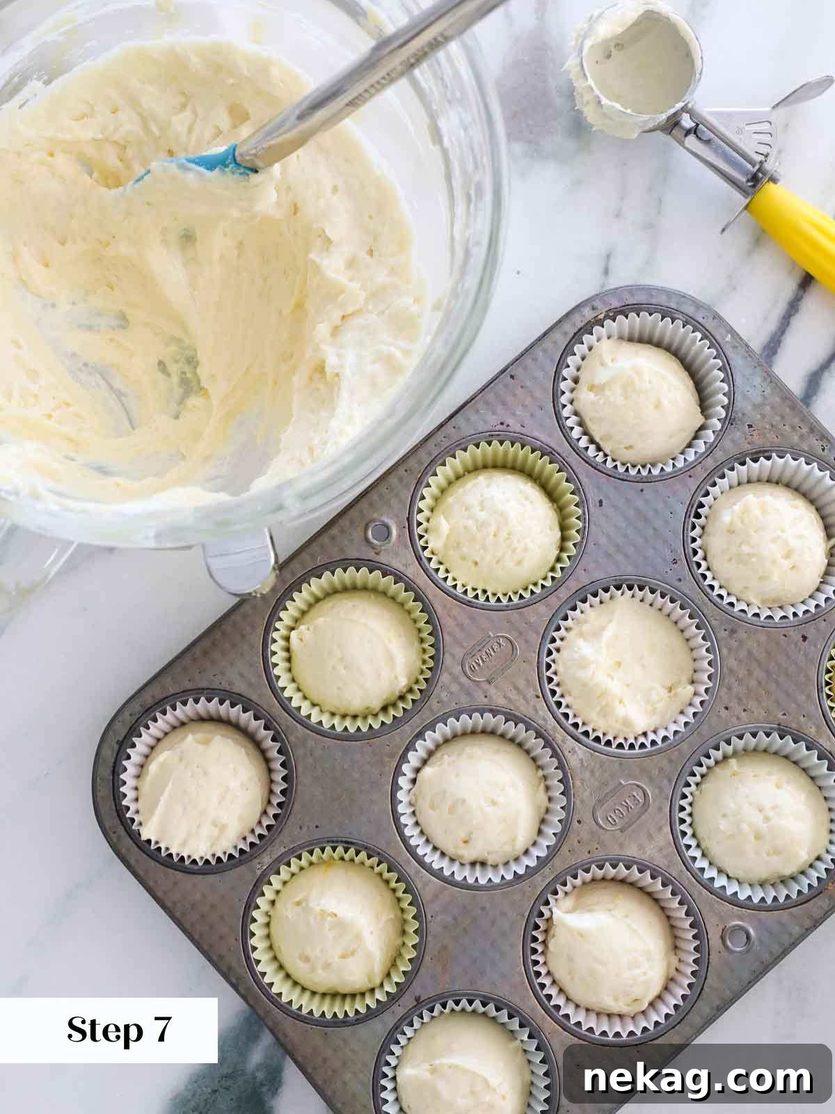 Sunshine Lemon Cupcakes 12 Lemon cupcake batter being carefully portioned into paper liners within a muffin tin.