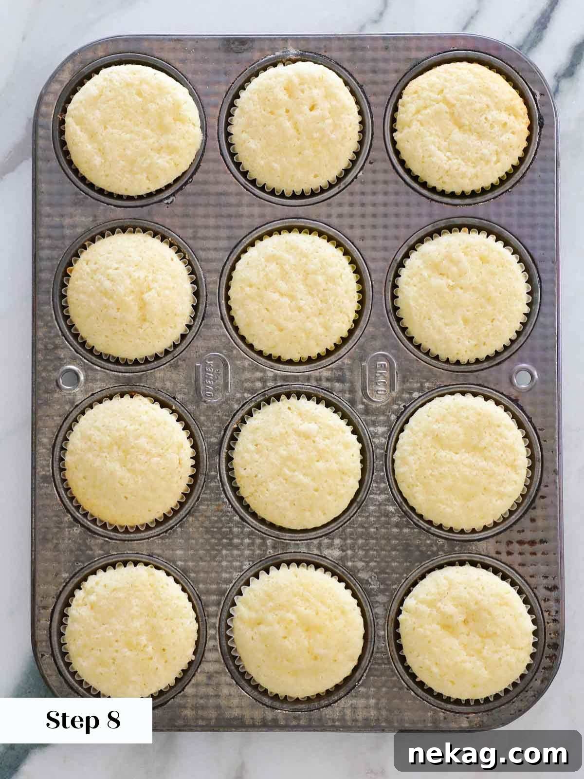 Sunshine Lemon Cupcakes 13 Freshly baked lemon cupcakes still in their paper liners, nestled in a muffin tin.