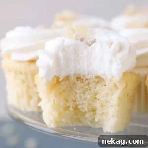 Sunshine Lemon Cupcakes 18 Interior texture of a lemon cupcake with lemon buttercream, showing its moist crumb.