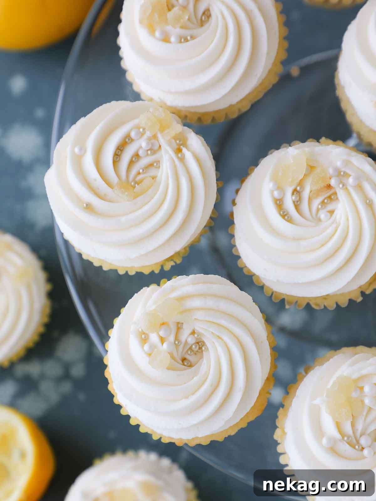 Sunshine Lemon Cupcakes 3 Frosted lemon cupcakes arranged beautifully on a vintage glass cake stand, ready to be served.