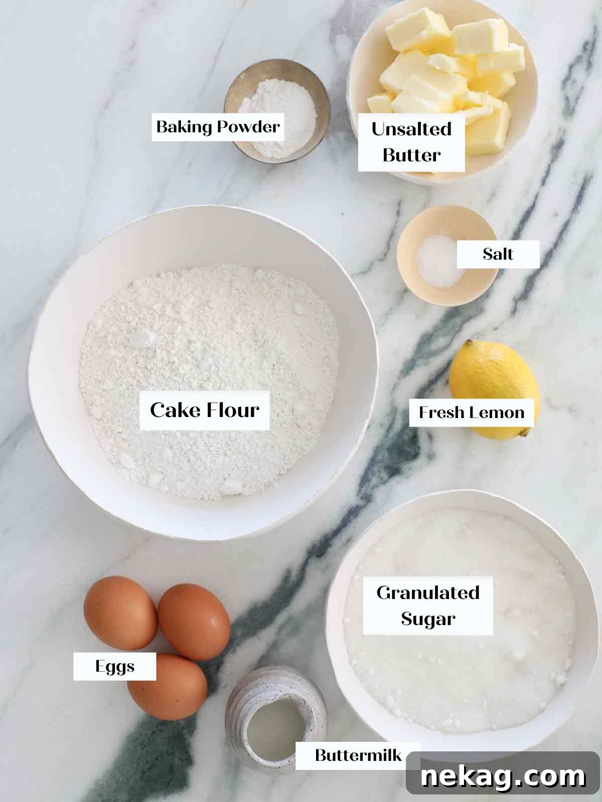Sunshine Lemon Cupcakes 4 A collection of fresh ingredients laid out for making lemon cupcakes, including lemons, butter, eggs, and flour.