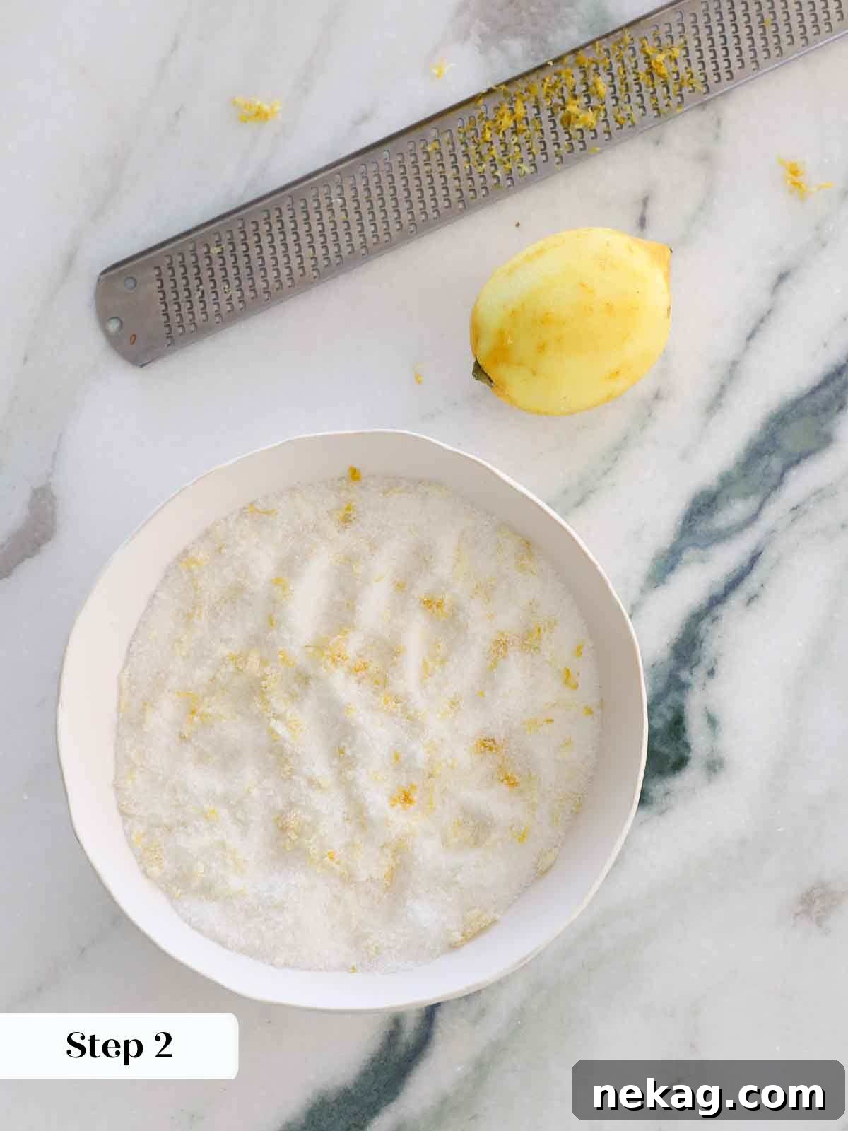 Sunshine Lemon Cupcakes 7 Lemon zest combined with granulated sugar in a white bowl, ready for baking.