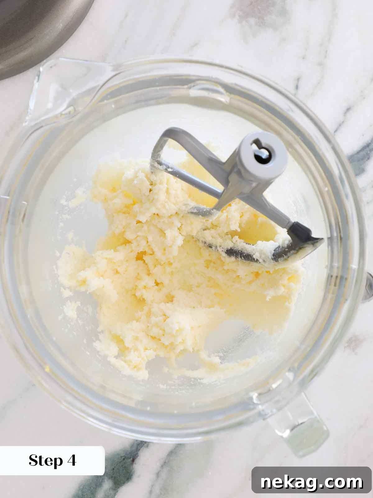 Sunshine Lemon Cupcakes 9 Perfectly creamed butter, sugar, and lemon zest mixture in a stand mixer bowl, indicating proper aeration.