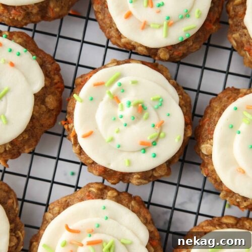 Creamy Carrot Spice Cookies 11 Top view of carrot cake cookies with cream cheese frosting swirled on top.
