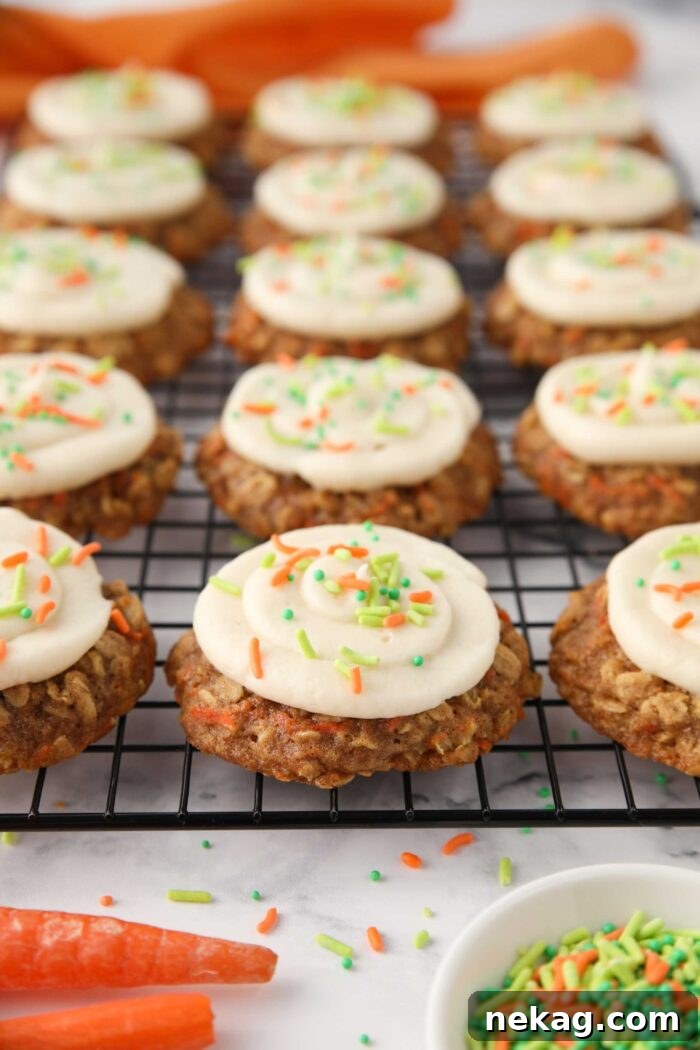 Creamy Carrot Spice Cookies 3 Oatmeal carrot cake cookies with cream cheese frosting and colorful sprinkles. A perfect spring dessert.