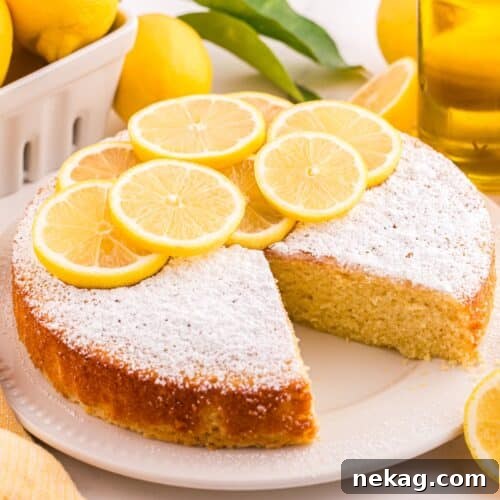 How to Bake Lemon Olive Oil Cake 11 Lemon olive oil cake on a plate with a slice removed.