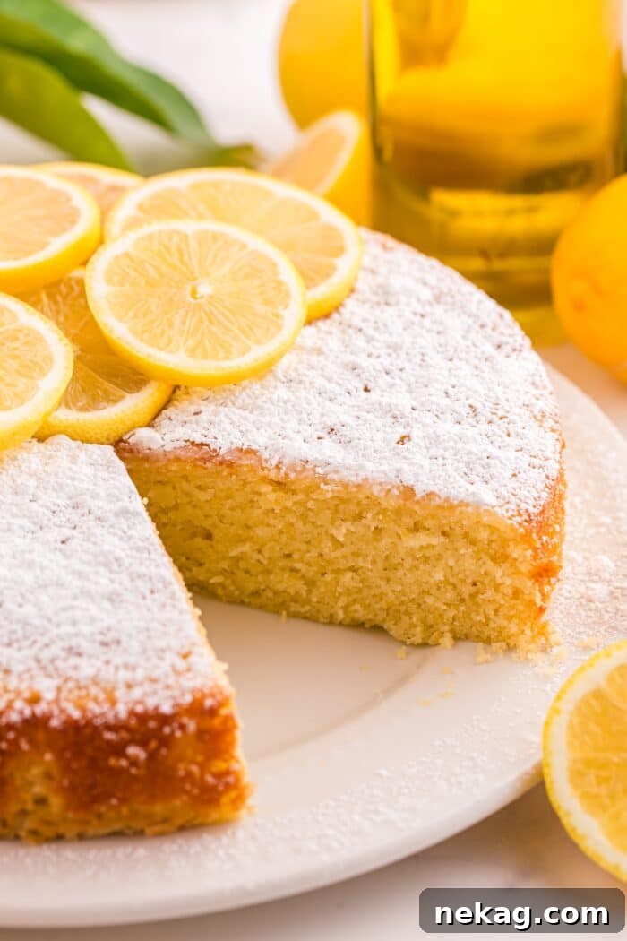 How to Bake Lemon Olive Oil Cake 10 Close up of olive oil lemon cake with a slice removed showing the inside of the cake.