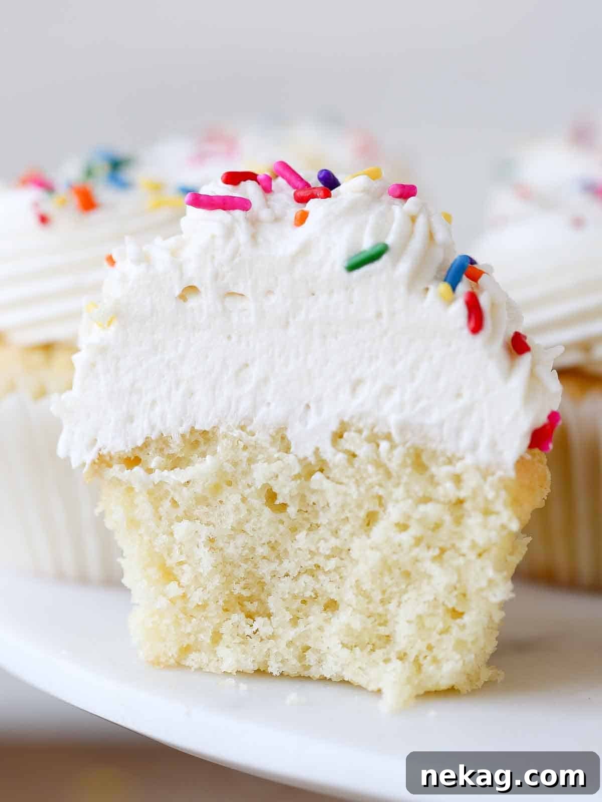Velvety Cooked Flour Frosting 2 Light, fluffy ermine frosting generously piped on a vanilla cupcake, showcasing its airy texture.