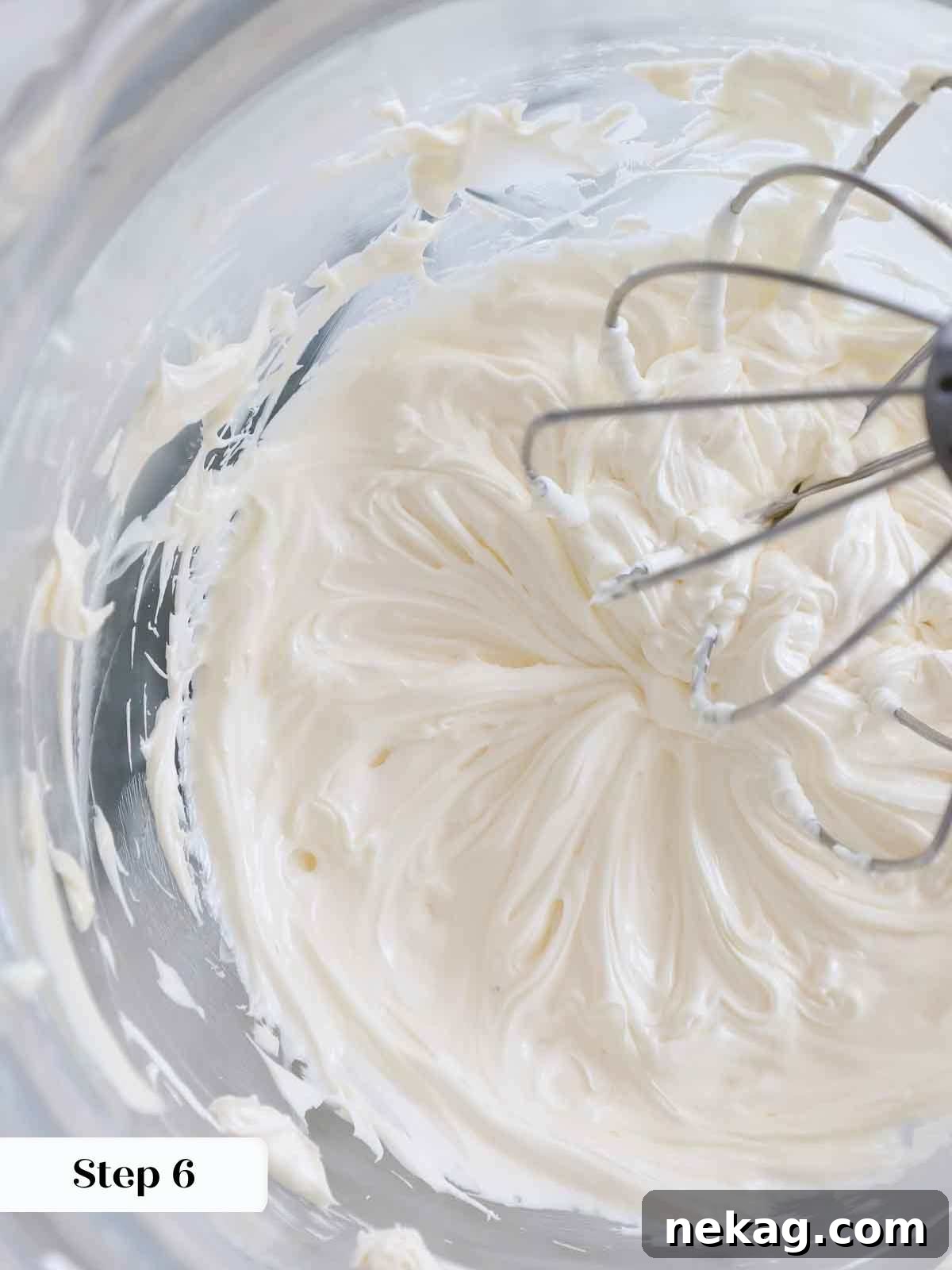 Velvety Cooked Flour Frosting 12 Butter being whipped to a light, fluffy, and almost white consistency in a stand mixer for ermine frosting.