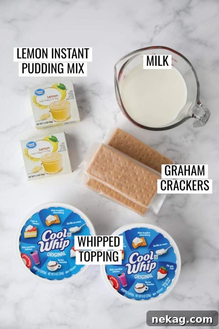 Neatly arranged ingredients for lemon icebox cake, including two boxes of instant lemon pudding mix, a carton of whole milk, a tub of whipped topping, and a box of graham crackers.
