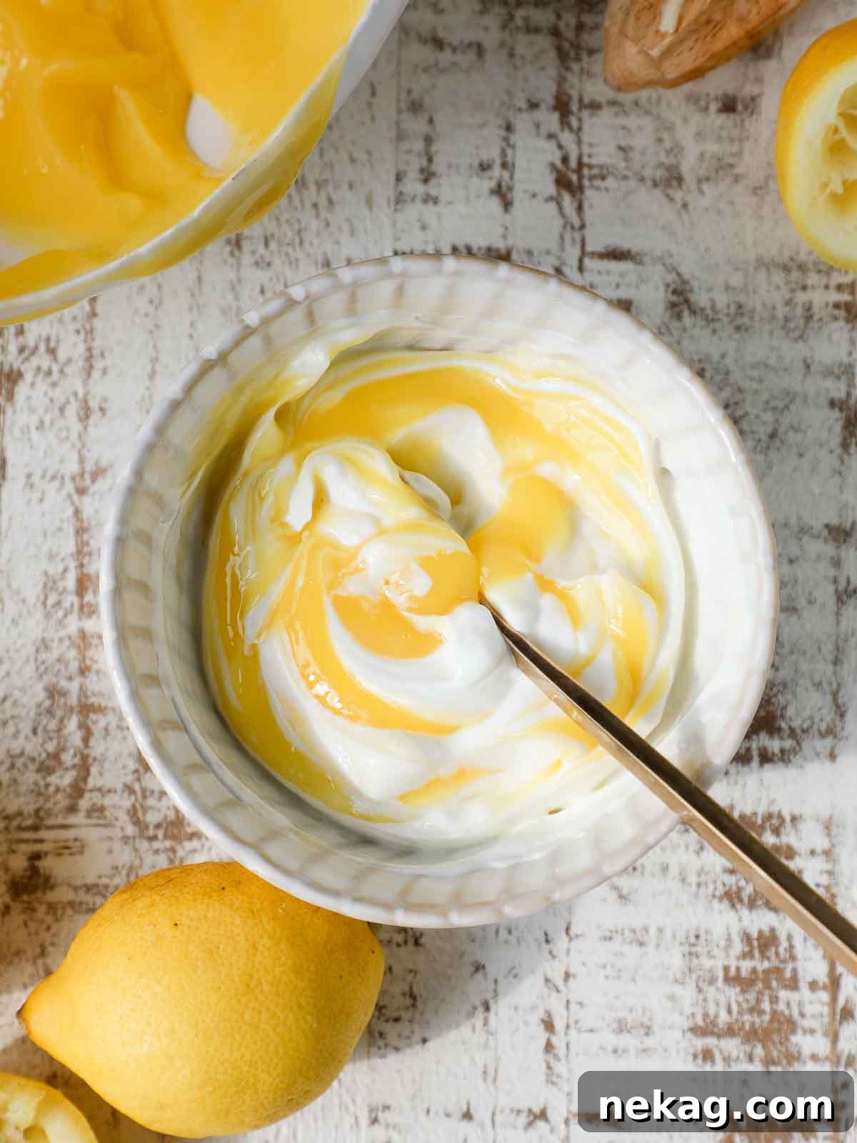 Smooth, vibrant lemon curd resting on a rustic wooden background, perfectly illustrating its rich texture and inviting color.