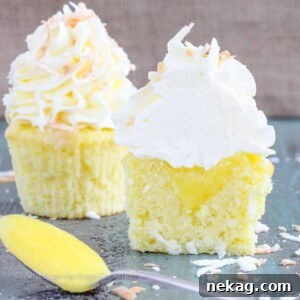 A close-up of Lemon Coconut Cupcakes, showcasing the moist coconut cake, lemon curd filling, and toasted coconut topping.