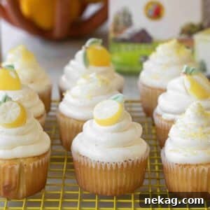 Elegant lemon elderflower cupcakes, topped with delicate candied decorations, ready for a special occasion.