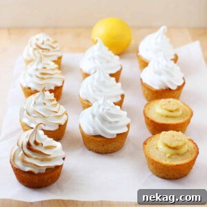 Three vertical rows of perfectly toasted Lemon Meringue Cupcakes, displaying their beautiful meringue swirls.