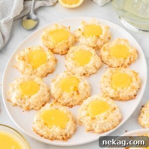 Close-up of fluffy Lemon Macarons topped with delicate flaked coconut, ready to be devoured.