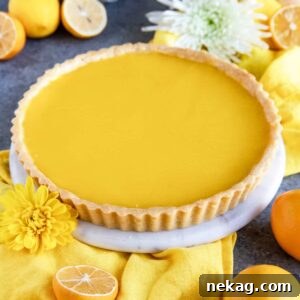 A luscious Meyer Lemon Tart, beautifully presented alongside a vibrant yellow cloth napkin.