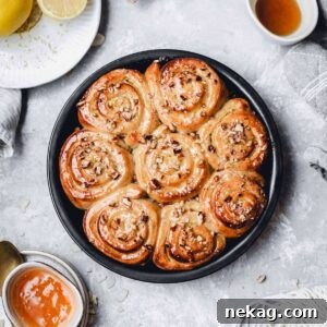 Vegan lemon curd rolls, beautifully arranged on a plate with various sauces on the side for dipping.