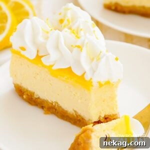 A delectable slice of lemon cheesecake with a small bite taken, highlighting its smooth texture and rich flavor.
