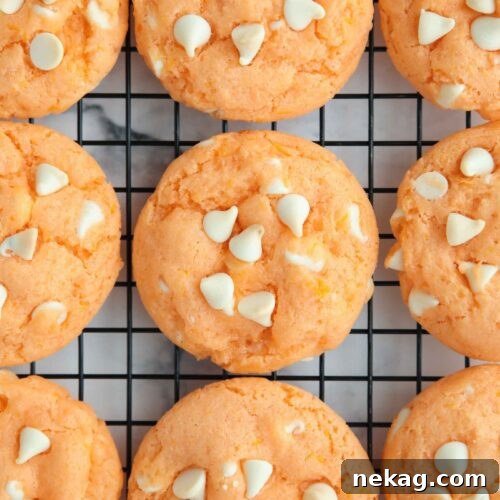 Orange creamsicle cookies cooling on a wire rack.