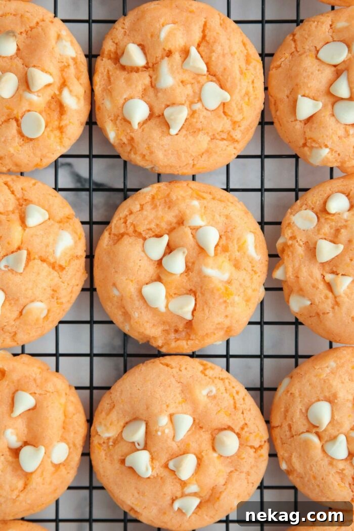 Orange Dreamsicle Delights 7 Freshly baked orange creamsicle cookies cooling on a wire rack, ready to be enjoyed.