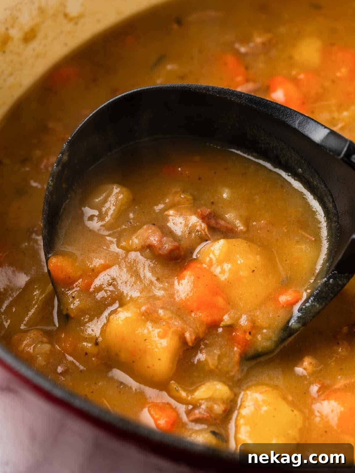 Hearty Lamb Stew 4 A black ladle scooping a generous portion of hearty lamb stew, showcasing its rich texture and ingredients.