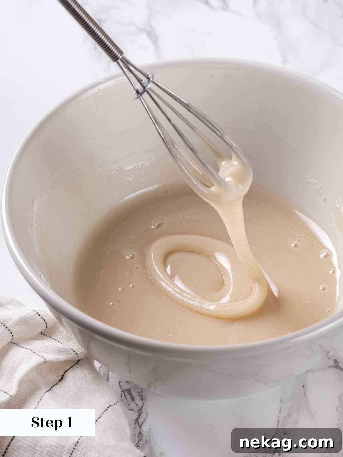 Rippled Golden Doughnuts 14 The smooth, thick maple glaze pouring effortlessly from a whisk into a bowl, demonstrating the perfect consistency for dipping.