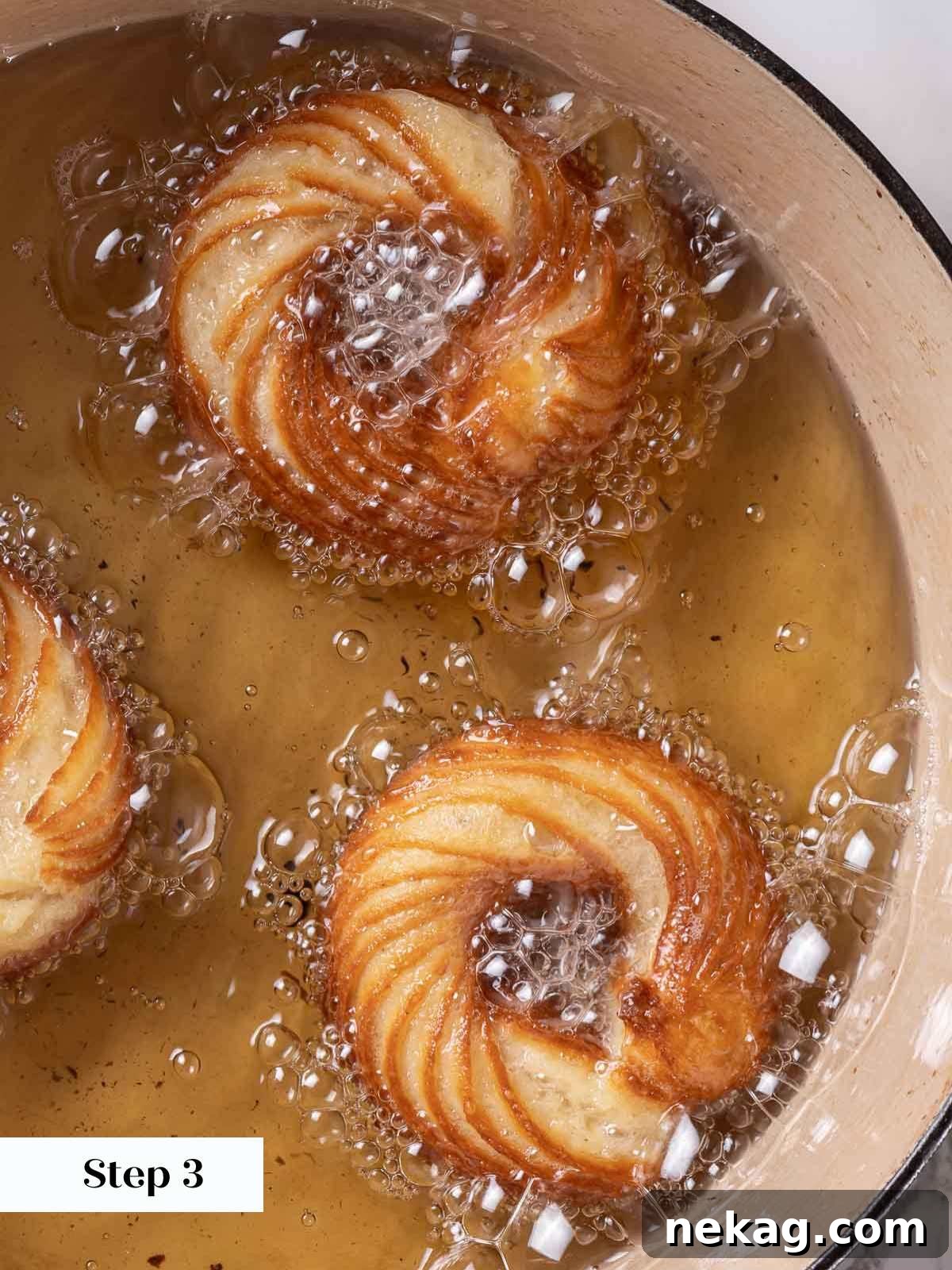 Rippled Golden Doughnuts 15 Three beautifully ridged French crullers actively frying in bubbling hot oil, turning golden brown.