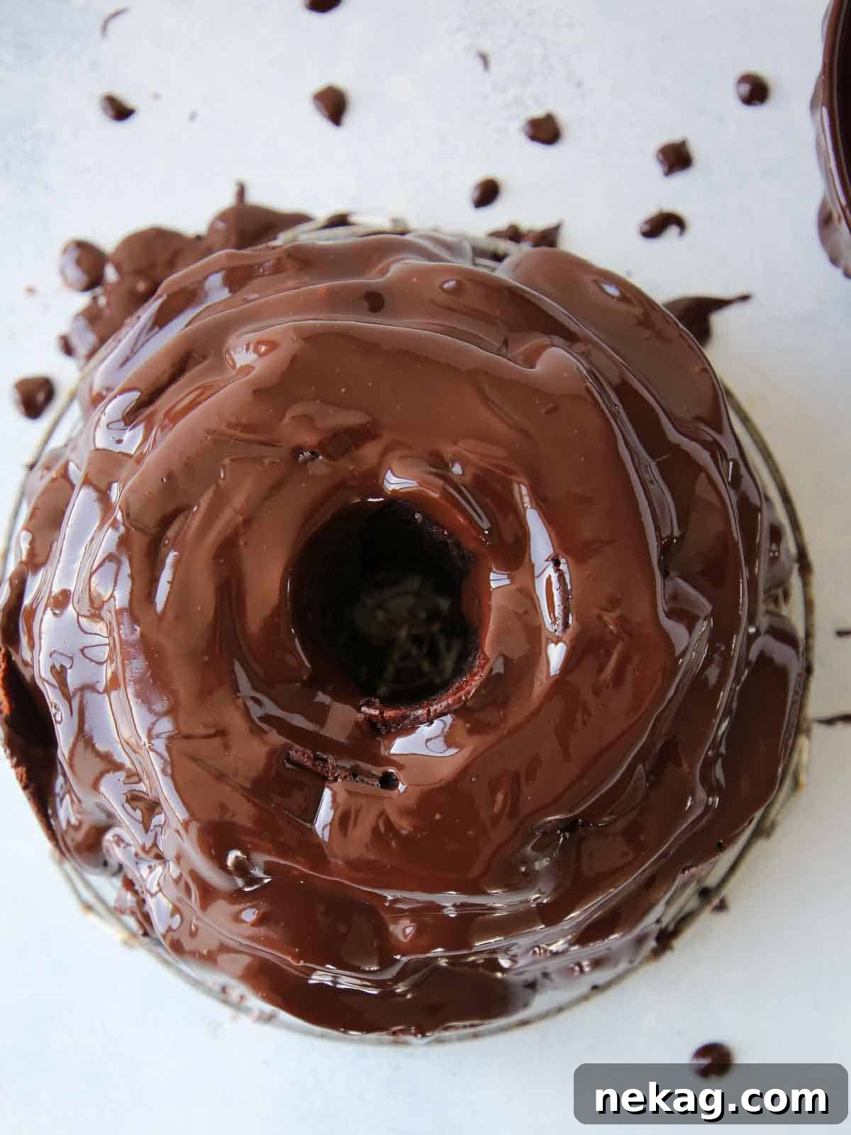 Mastering Chocolate Ganache 3 chocolate bundt cake covered in chocolate ganache.