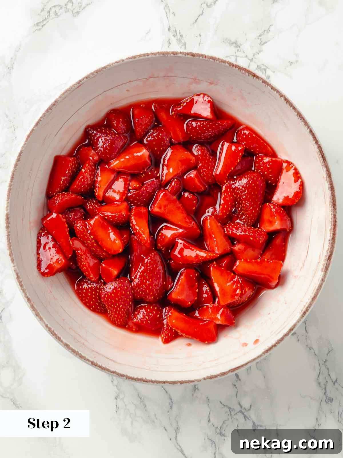 Silken Buttermilk Delight 12 Macerated strawberries in a bowl, having released their juices.