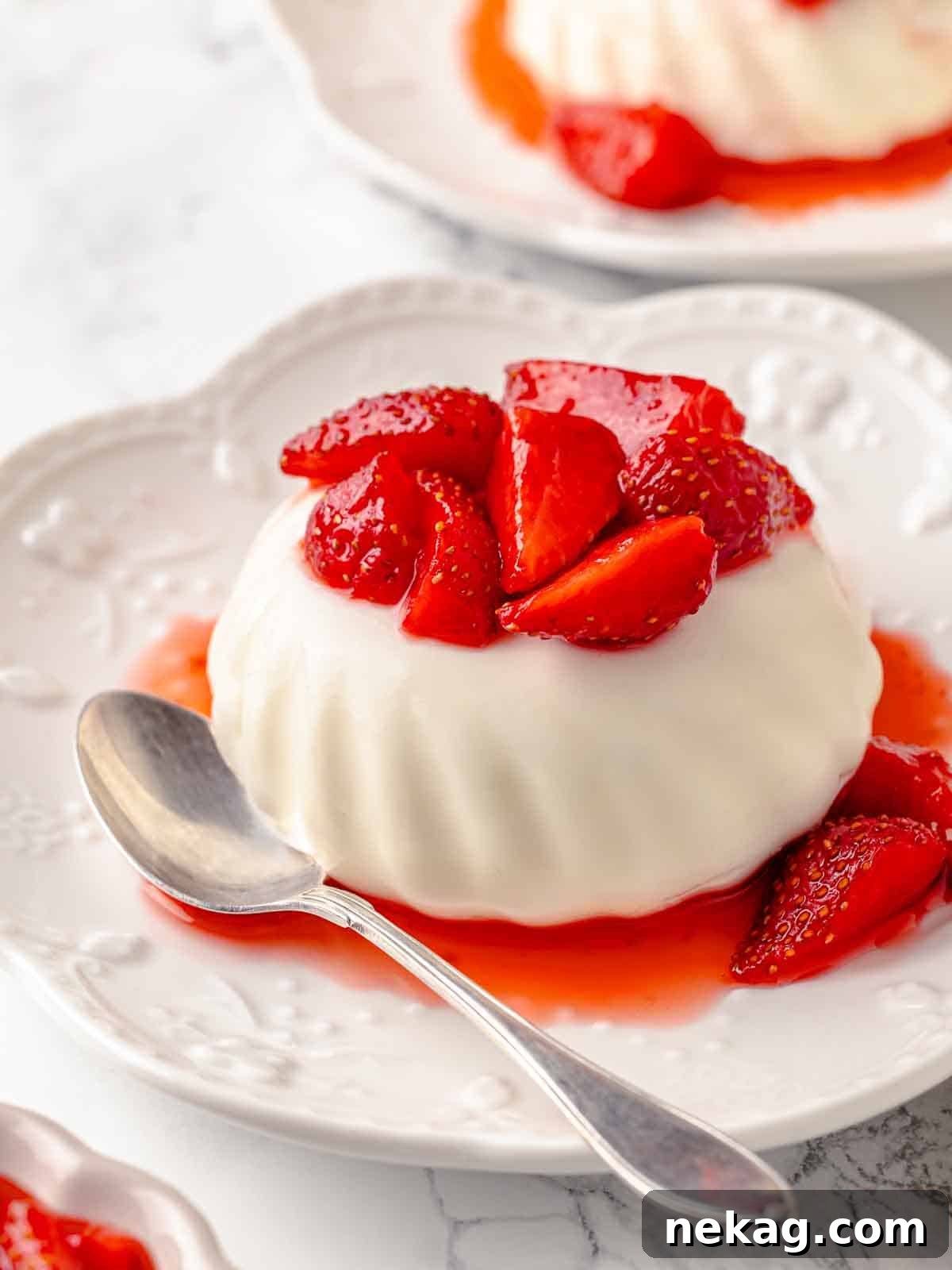 Silken Buttermilk Delight 5 Beautifully unmolded buttermilk panna cotta served with fresh strawberries.