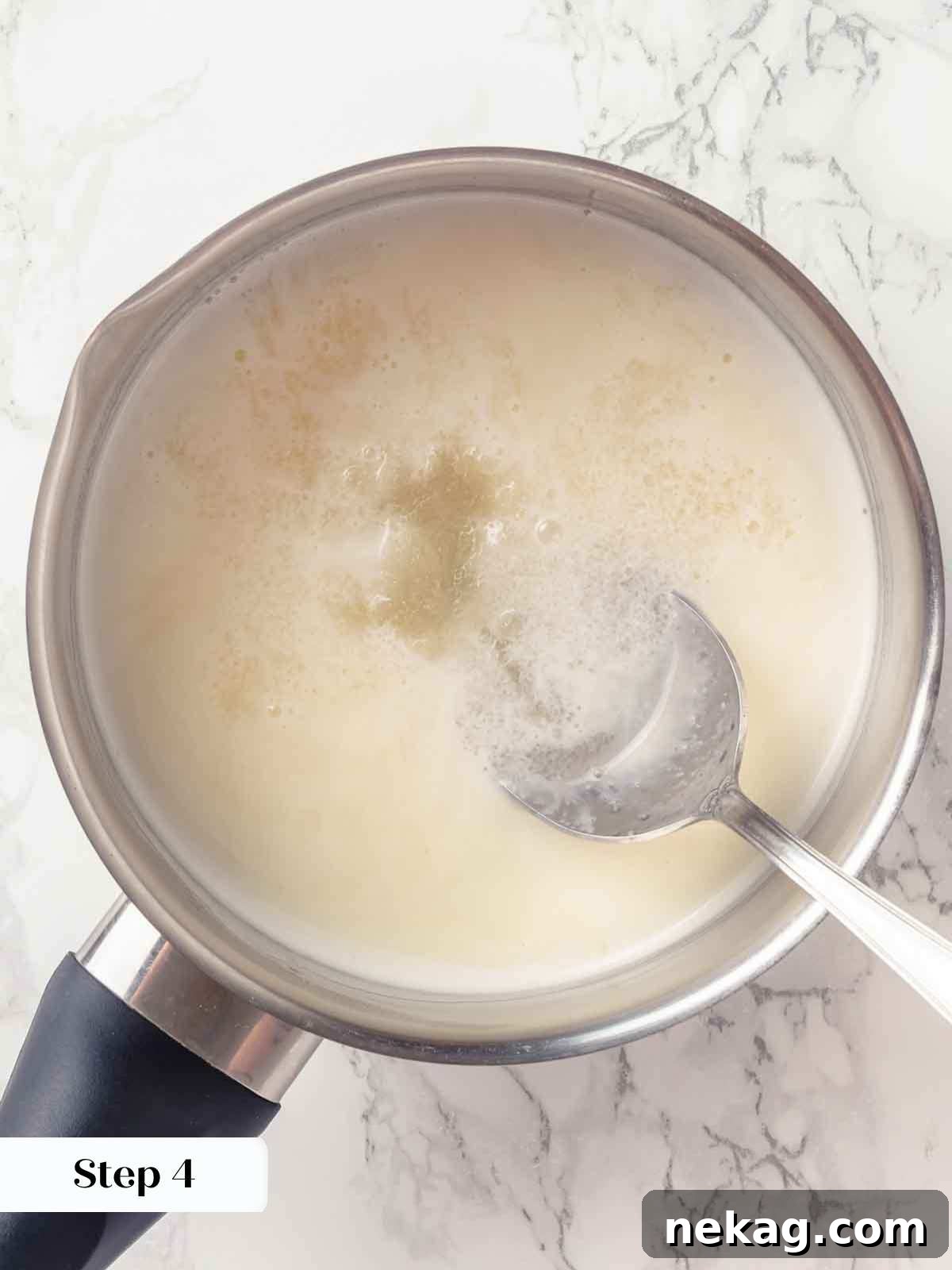 Silken Buttermilk Delight 8 Bloomed gelatin being melted into hot cream mixture in a saucepan.