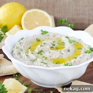 Silky, smoky Baba Ganoush garnished with fresh parsley and olive oil, a perfect creamy eggplant dip.