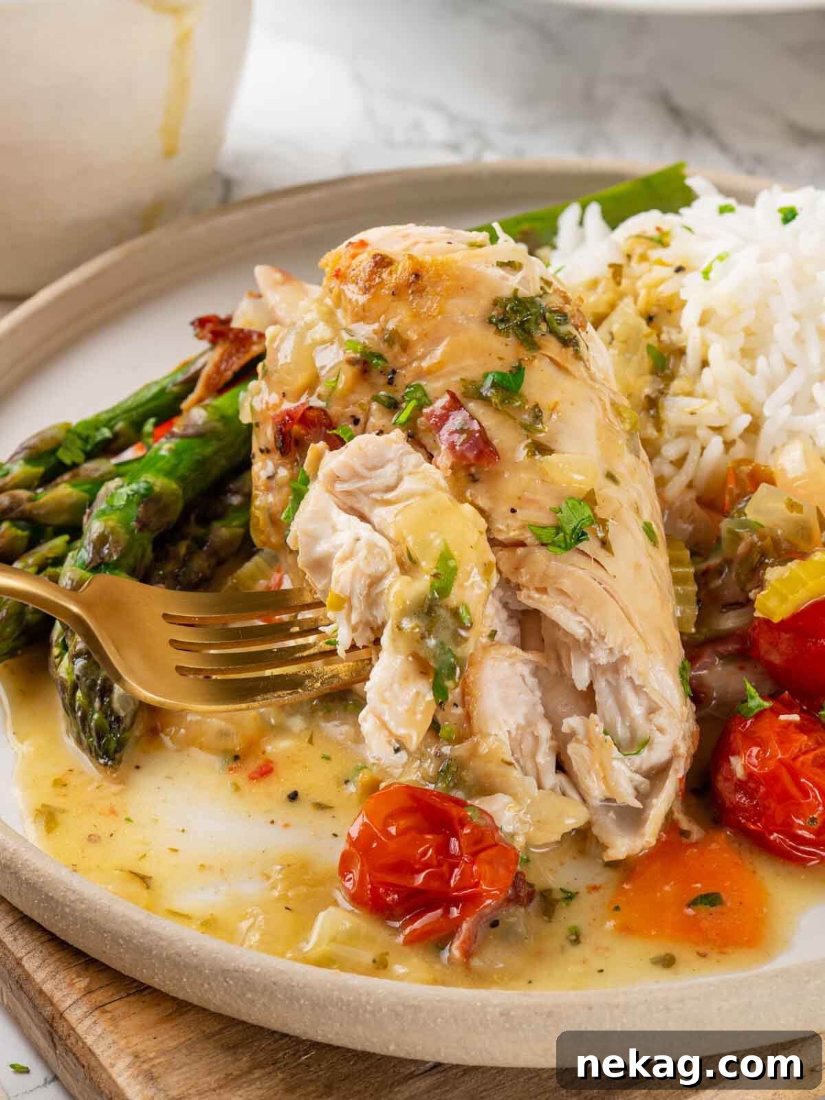 Chicken in wine sauce with a gold fork.