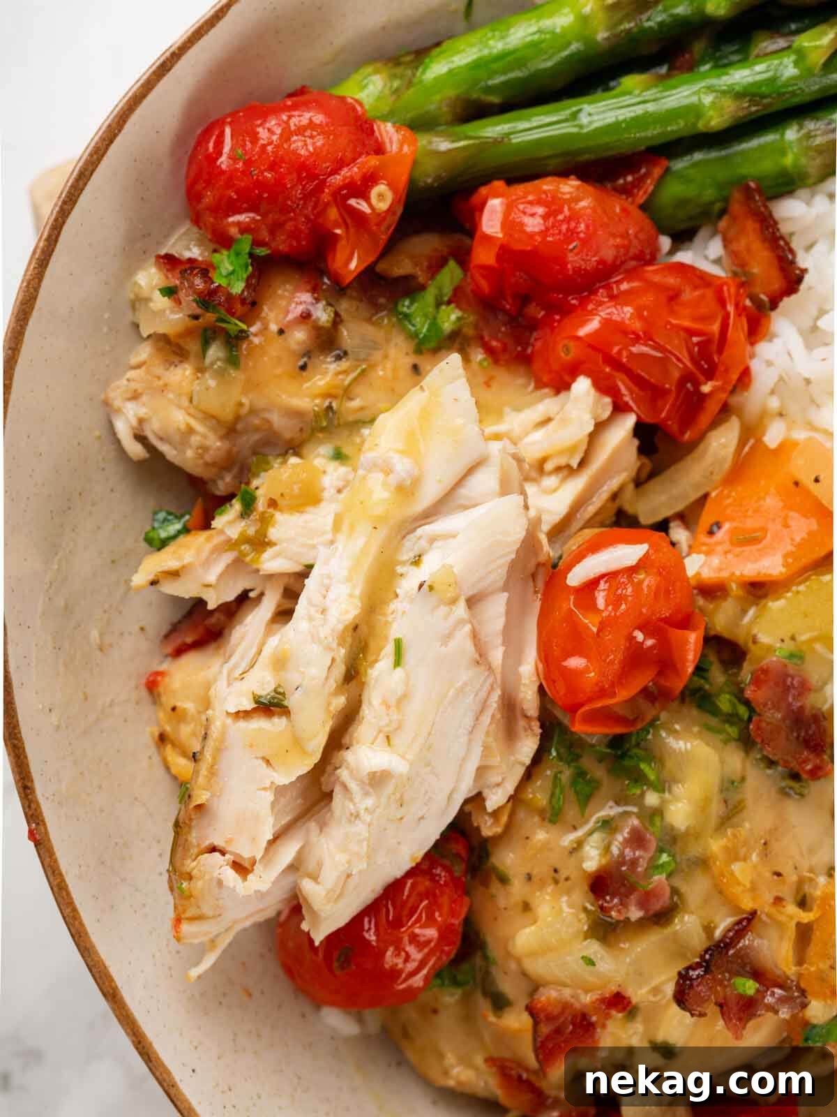 Chicken in wine sauce with asparagus on the side.