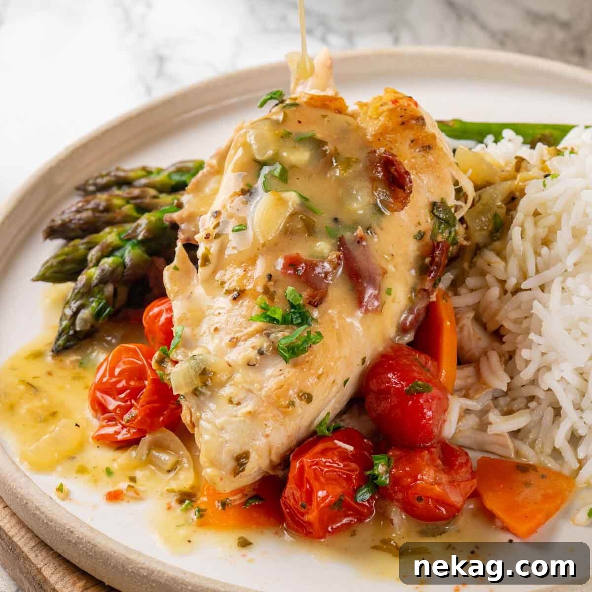 Chicken in wine sauce on a white marble countertop.