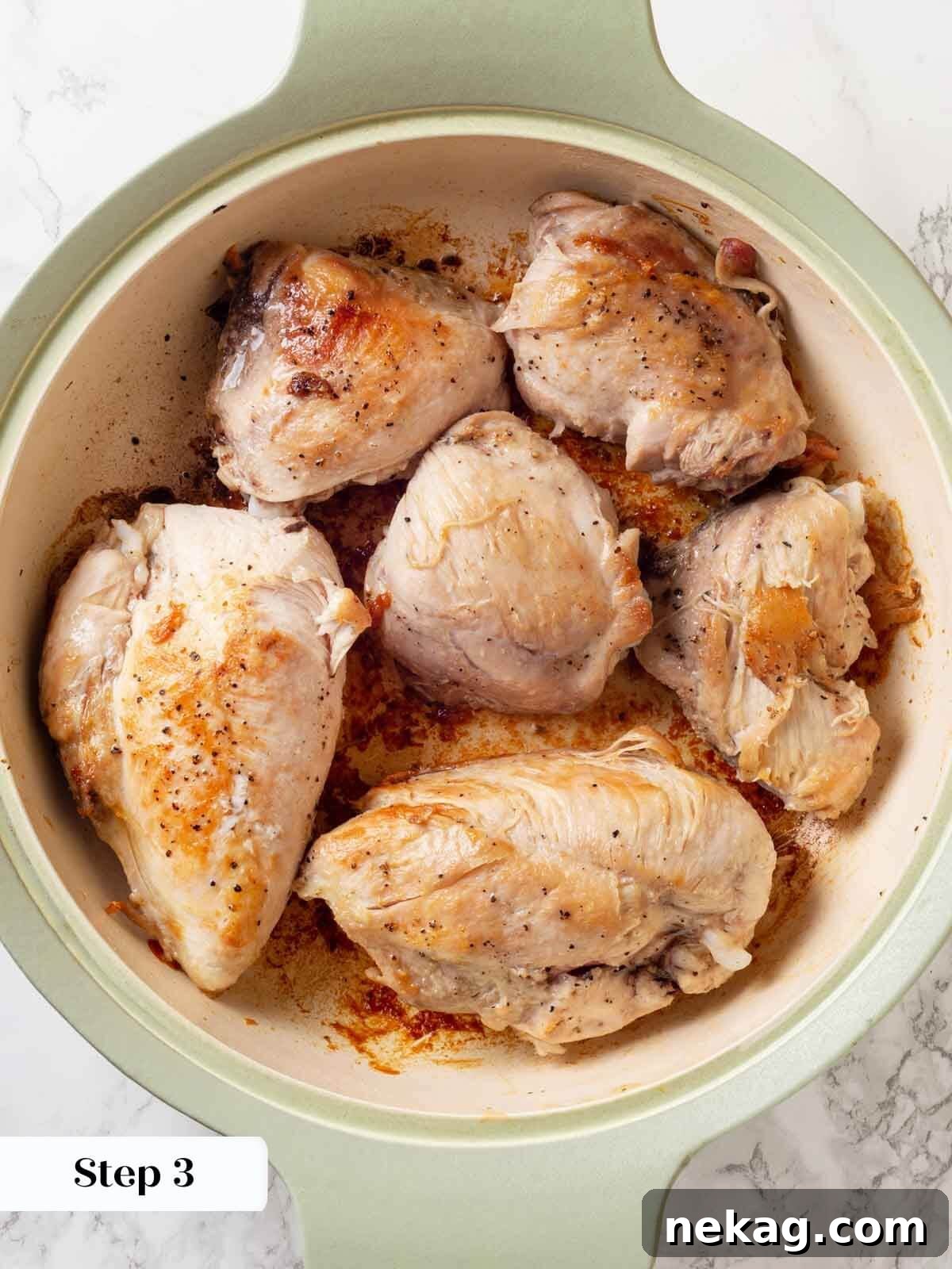 Chicken in wine sauce browned on both sides.